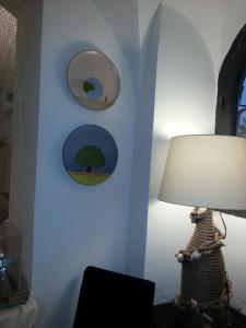 a room with a lamp and some pictures on the wall at Hotel Argentina in Santa Margherita Ligure