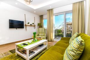 a living room with a couch and a tv at Kybele Suites in Kaş