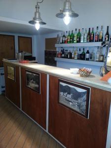 a kitchen with a bar with pictures on it at Hotel Argentina in Santa Margherita Ligure