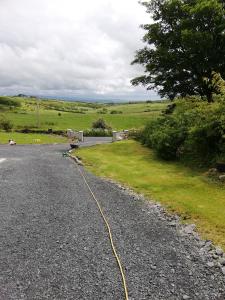 a road with a yellow hose on the side at Peace and Tranquility in Ballymote