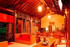 a living room with a red couch and a table at D'Wahana Resort in Gili Trawangan