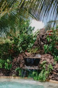a statue of an elephant sitting next to a fountain at Paua Hotel Boutique in Pipa