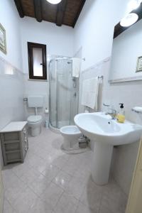 a bathroom with a sink and a shower and a toilet at By the Sea in Terrasini +49 photos