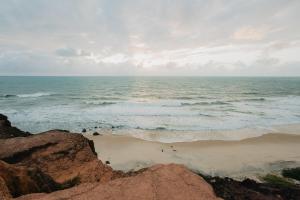 a view of the ocean on a cloudy day at Paua Hotel Boutique in Pipa