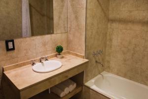 a bathroom with a sink and a bath tub at Mar del Este in San Bernardo +24 photos