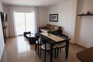 a living room with a table and chairs and a couch at Mar del Este in San Bernardo