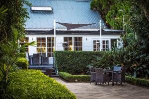 a house with a porch and a lawn chair at Mercure Gerringong Resort in Gerringong
