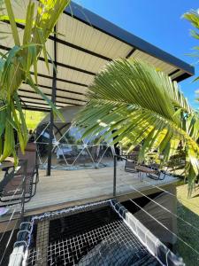 瓜塔佩的住宿－Glamping Montecarlo Domo Geodesico y Sauna Finlandés Guatapé，一个带桌椅和棕榈树的庭院