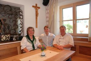a group of three people sitting at a table at Hotel Gasthof Erbhof Anderlhof in Leogang