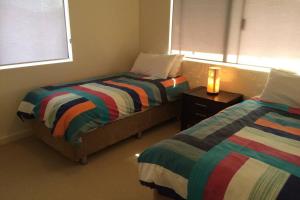 Ένα ή περισσότερα κρεβάτια σε δωμάτιο στο Dolphin Shores by the Blackwood River
