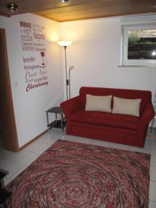 a living room with a red couch and a rug at Nettetal - free2beme in Nettetal