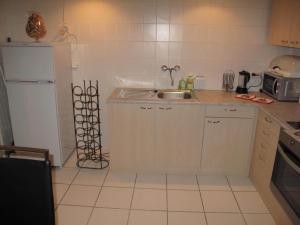 a small kitchen with a sink and a refrigerator at Nettetal - free2beme in Nettetal