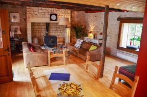 a living room with a couch and a fireplace at Parc de vacances La Draille in Souillac