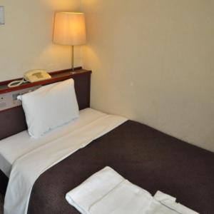
a hotel room with two beds and a lamp at Hotel Select Inn Nagano in Nagano

