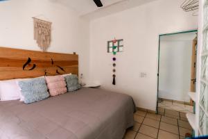 a bedroom with a bed with two pillows on it at Habitaciones Samy in San Francisco