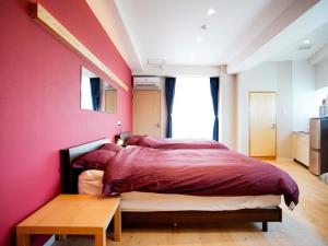 Llit o llits en una habitació de Mcity in Furujima