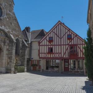 a large building with red and white at Au temps d'Autrefois in Nolay