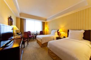 Postel nebo postele na pokoji v ubytování Clarion Hotel Tianjin