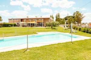 a swimming pool in front of a house at Tocchi di Puglia in Castellaneta Marina