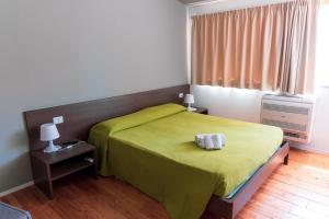 una camera con un letto e una coperta verde di Tocchi di Puglia a Castellaneta Marina