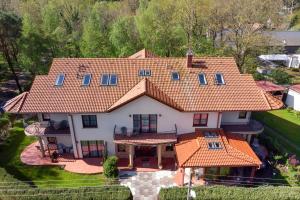 an aerial view of a house with an orange roof at Willa u Wójta in Pobierowo
