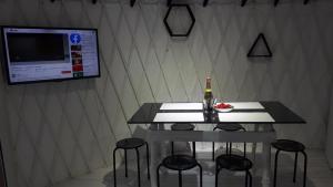 a table with four chairs and a bottle of beer at Глемпінг luxury in Lypovets