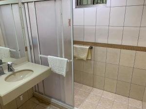 a bathroom with a sink and a shower stall at Xitou Youth Activity Center in Lugu