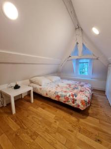 a bedroom with a bed and a table in it at Château des Bosquets in Étretat