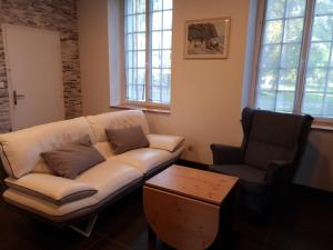 a living room with a couch and a coffee table at Château des Bosquets in Étretat