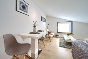 a living room with a white table and chairs at Apartments Sinisa - City of Krk in Krk +18 photos