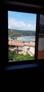 a view from a window of a city and the ocean at Finestra sul porto in Marina di Camerota