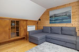 a living room with a couch and a painting on the wall at Family Vacation House with Garden & Parking by Renters in Zastań