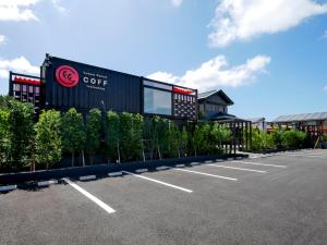 a parking lot in front of a building at HOTEL R9 Kujukuri "ex Casual Resort COFF Ichinomiya" in Ichinomiya
