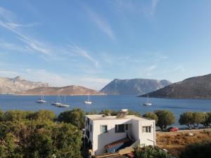 a house with a view of the water and boats at Petroula Apartments II in Emborios