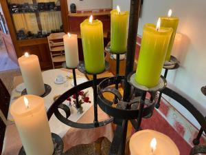 a candle holder with green candles on a table at Kreuzerhof Hotel Garni in Rothenburg ob der Tauber