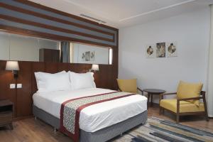 Postel nebo postele na pokoji v ubytování Biz Hotel Apartments