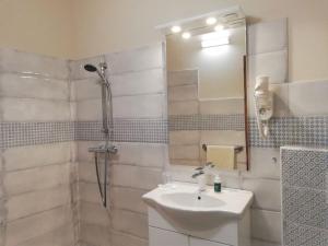 a white bathroom with a sink and a shower at Haus Monti in Maria Lanzendorf