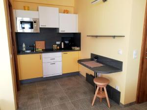 a small kitchen with a counter and a sink at Haus Monti in Maria Lanzendorf +38 photos