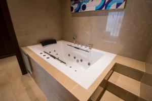 uma banheira na casa de banho com em Belad Bont Resort em Salalah