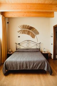 a bedroom with a bed with a metal head board at NIDO DEL GELSO in Verona