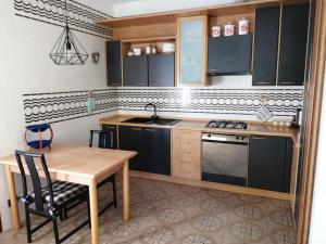 a kitchen with a wooden table and a table and chairs at Casa vacanze Donatella in Carenno