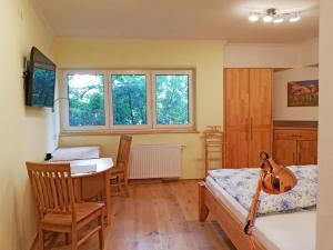 a bedroom with a bed and a table and chairs at Haus Monti in Maria Lanzendorf