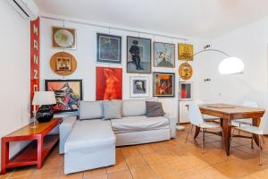 a living room with a couch and a table at Milan Retreats in Milan