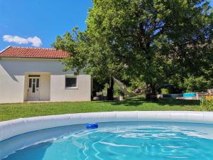 a large swimming pool in front of a house at Getaway house Loko in Trebinje
