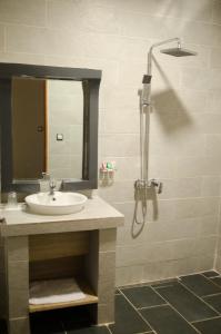 a bathroom with a sink and a shower at Hôtel MENABE'L in Antsirabe +20 photos