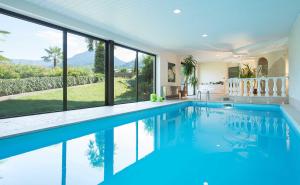 an indoor swimming pool in a house with windows at Weinsepphof Ferienwohnung 6 in Lana