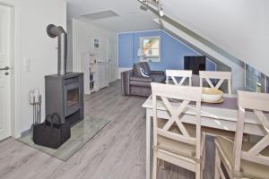 a living room with a wood stove in it at F-1059 Landhaus am Rebstock FeWo Möwe ruhige Lage in Blieschow