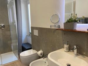 a bathroom with a sink and a shower and a mirror at ON the RAIL by Arcotrilogy-Homes in Arco