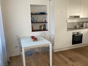 a small white table and chairs in a kitchen at ON the RAIL by Arcotrilogy-Homes in Arco