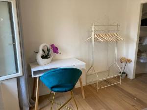 a room with a desk and a blue chair at ON the RAIL by Arcotrilogy-Homes in Arco
